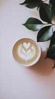 beautiful latte art design in white cup, surrounded by green leaves, evokes sense of calm and warmth photo