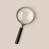 a magnifying glass on beige background, showcasing minimalistic design and clarity photo