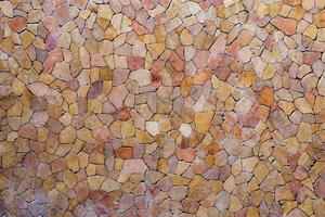 Tile pieces are arranged like a mosaic on the wall. Abstract background of wall texture. photo