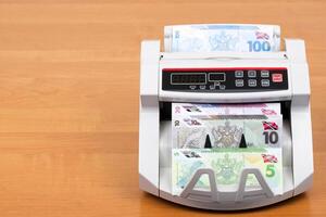 Trinidad and Tobago money - dollar in the counting machine photo