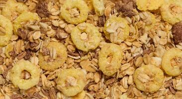 Crunchy breakfast cereal and oat granola mix, featuring puffed corn rings, toasted oats, and nuts. A nutritious and delicious option for a healthy meal. photo