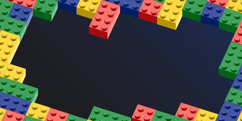a colorful toy brick blocks wall with a black background