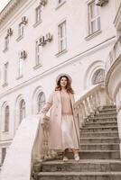woman in elegant coat and hat against an intricate architectural backdrop, harmoniously blending modern fashion with historical allure. The soft daylight adds to its timeless appeal. photo