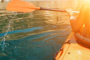 Kayak paddle sea vacation. Person paddles with orange paddle oar on kayak in sea. Leisure active lifestyle recreation activity rest tourism travel photo