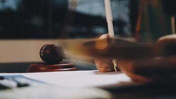 A judge's gavel on a desk with a pen and paper video