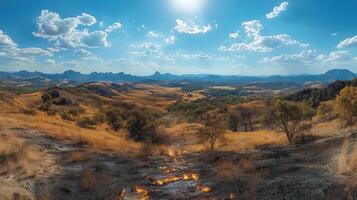 A panoramic view of a mountain range with grass and trees photo