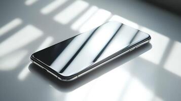 A silver iphone sitting on a table with sunlight shining on it photo