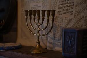 A gold menorah is displayed on a shelf in a jewish home photo