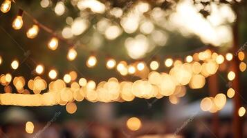 Blurred strings of illuminated decorative lights create a warm, festive, and dreamy ambiance, perfect for celebrations and outdoor events. photo