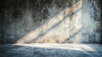 Light streams across a concrete room, creating a dramatic contrast between shadows and illumination. The worn texture adds depth and intrigue. photo