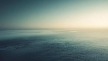 Serene ocean view with a light sky fading into fog over the horizon, creating a sense of calm and vastness, inviting contemplation. photo