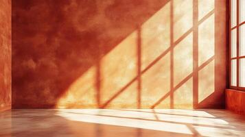 Sunlight streams into a terracotta room, casting geometric shadows across the textured wall and floor, creating a play of light and depth. photo