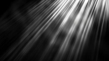 Rays of light stream diagonally across a dark background, illuminating the scene with ethereal beams and shadows. Black and white contrast. photo