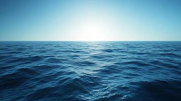 A breathtaking view of the endless ocean, where the horizon seamlessly merges with the clear, bright sky under the warm sunlight. photo