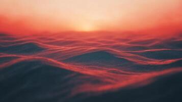 A mesmerizing horizon with soft waves painted in fiery hues of red, orange, and pink, mirroring the serene sunset above the rippling water. photo