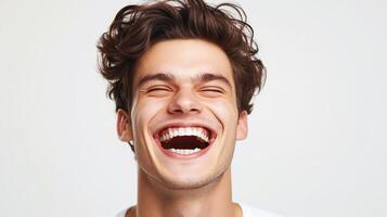 Euphoric laughter fills the air as a young man throws his head back in unrestrained joy, showcasing his infectious grin and carefree spirit. photo