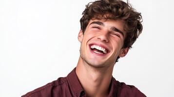 Man with curly hair laughs with joy, eyes closed, showcasing his bright smile against a stark white backdrop. photo