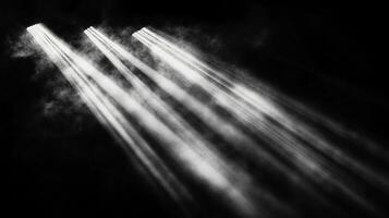 Monochromatic image depicting light beams piercing through a smoky, dark setting. A dramatic interplay of brightness and shadows. photo