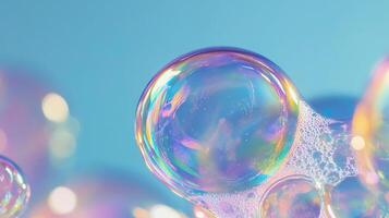 Abstract iridescent soap bubble composition. Dreamy aesthetics with colorful and pastel reflections on a blue background. Macro details of a fluid. photo