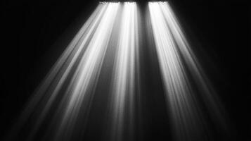 Dramatic shafts of light pierce the darkness, creating a visual spectacle of contrasting tones. The image evokes a sense of mystery. photo