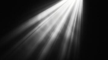 Rays of light shine dramatically from an unseen source, piercing through the darkness creating an ethereal and captivating atmosphere. photo