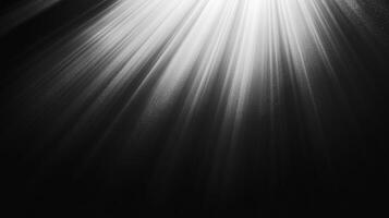 Light streams powerfully. Rays cascade down from above, casting the scene in dramatic monochrome contrast. A captivating play of light and shadow. photo
