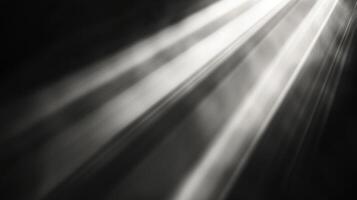 Rays of light pierce through a dark space, creating a visual contrast between luminosity and shadow, with ethereal illumination and atmosphere. photo