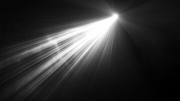 A bright, white light beam shines down into a dark background, creating a dramatic contrast between light and shadow, perfect as a background. photo