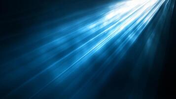 Abstract view of blue and white light rays emanating from the upper right on a dark background, creating a stunning visual display. photo