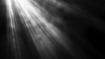Striking black and white photograph showcasing ethereal rays of light piercing through a dark atmosphere, creating a dramatic contrast. photo