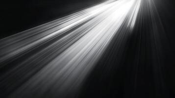 Radiant beams of light pierce through the darkness, creating a dramatic and ethereal scene. The monochromatic palette enhances the effect. photo