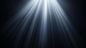 Illuminating rays of light descend from above, casting a celestial glow in a dark space. Streaks create a sense of divine intervention. photo