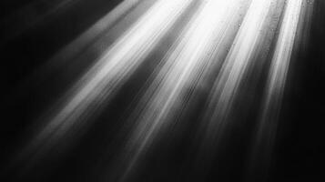 Striking black and white image showcasing dramatic light rays piercing through darkness, creating a captivating interplay of light and shadow. photo