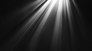 Rays of light stream down in the darkness, illuminating the unseen below. The glow creates ethereal contrast. photo