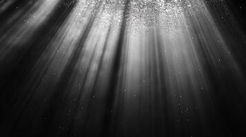 Rays of light descend from above, illuminating the darkness with a soft, ethereal glow. A cosmic dance of shadows and highlights. photo