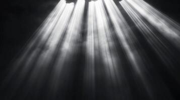 Ethereal light streams down through a hazy atmosphere, creating a dramatic and captivating scene in shades of gray. Striking and mysterious. photo