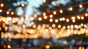 Blurred string lights create a warm and inviting ambiance for an outdoor gathering. Warm lighting in the evening light creates a calm feeling. photo