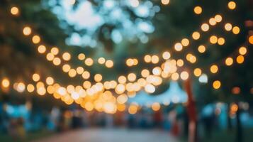Atmospheric outdoor event illuminated by string lights creates a warm, inviting ambiance. Festive and magical setting under the trees. photo