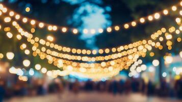 Blurred street scene illuminated with glowing string lights, casting a warm, inviting ambiance over a crowd of indistinct figures. photo