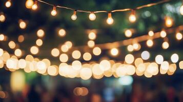 String lights illuminate a festive outdoor event, casting a warm glow and creating a joyful ambiance. Perfect for celebrations and gatherings. photo