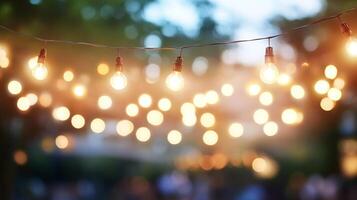 String lights illuminate a blurred background, creating a warm and inviting atmosphere. Perfect for outdoor events and cozy gatherings. photo