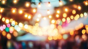 Blurred view of festive string lights creating a warm, inviting glow, suggesting a celebration or outdoor gathering at twilight. photo