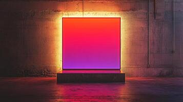Illuminated gradient panel against concrete wall. Modern art display with vibrant colors and minimalist design in a raw industrial setting. photo