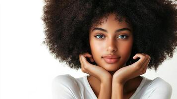 Striking portrait of a woman with a large, natural afro hairstyle, resting her chin on her hands. She's posing in front of a clean background. photo