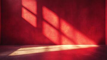 A red room is lit with sunlight streaming through a window, casting shadows on the wall and floor, creating warm tones and an interesting pattern. photo