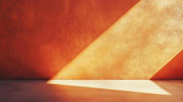 Sunlight creates a warm, geometric pattern on a textured wall, casting a sharp shadow across a plain floor. Abstract color and light. photo