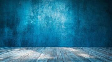A textured blue wall creates a dramatic backdrop with a weathered wooden floor illuminated by a soft, diffused light in a studio setting. photo