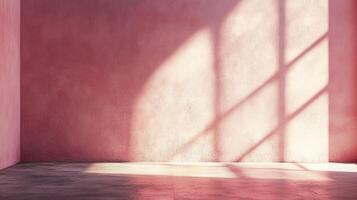 Soft light and shadows cast an organic geometric pattern against a pink textured wall with a rustic floor. Empty interior evokes peace. photo