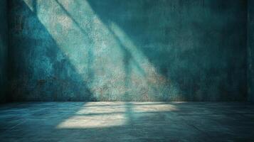 Empty cyan room with concrete walls and floor, illuminated by sun rays streaming from unseen windows, creating a serene ambiance. photo