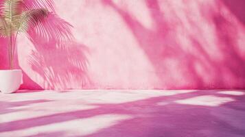 A vibrant pink wall adorned with playful shadows from palm leaves, creating a tropical ambiance indoors with a potted plant completing the scene. photo